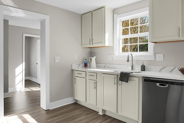 kitchen with dishwasher, dark hardwood / wood-style floors, sink, white cabinets, and light stone counters