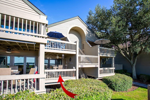 view of side of home with outdoor dining area and ceiling fan