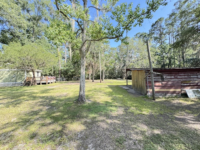 4589 Prices Bridge Ln, Walterboro, SC 29488 - view of green lawn with a wooden deck and view of wooded area