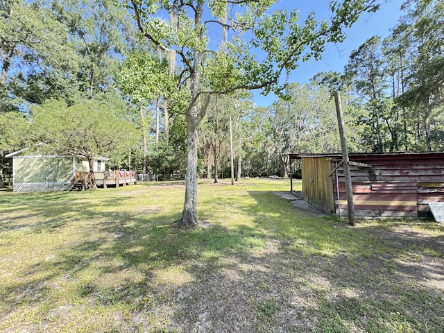 4589 Prices Bridge Ln, Walterboro, SC 29488 - view of grassy yard with a wooden deck and view of wooded area