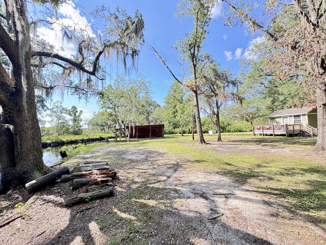 4589 Prices Bridge Ln, Walterboro, SC 29488 - view of yard featuring a deck, an outdoor structure, and a pole building