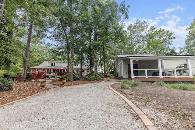 206 Chaussee Blvd, Summerville, SC 29483 - view of front of property with metal roof, driveway, a wooden deck, and a porch