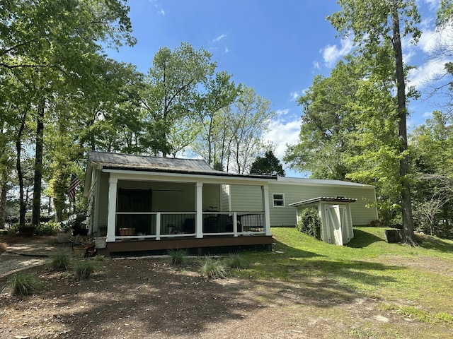 206 Chaussee Blvd, Summerville, SC 29483 - back of house featuring covered porch, metal roof, and a lawn