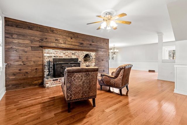 206 Chaussee Blvd, Summerville, SC 29483 - living area featuring a brick fireplace, a ceiling fan, wood finished floors, and wooden walls