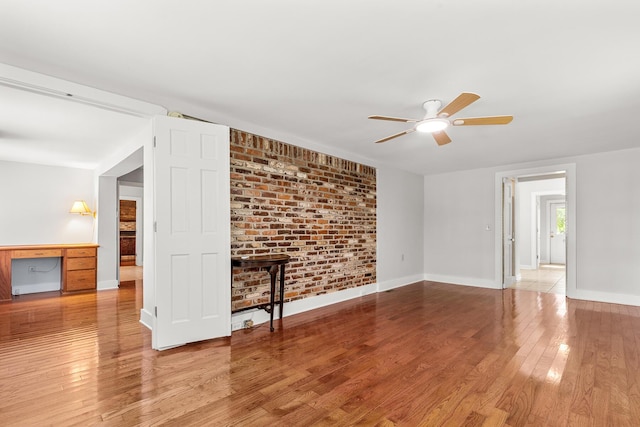 206 Chaussee Blvd, Summerville, SC 29483 - unfurnished living room with ceiling fan, wood finished floors, baseboards, and brick wall