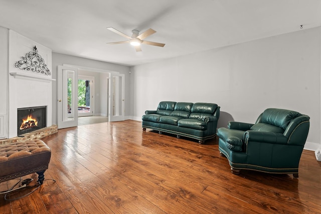 206 Chaussee Blvd, Summerville, SC 29483 - sitting room featuring a ceiling fan, wood-type flooring, a lit fireplace, and baseboards