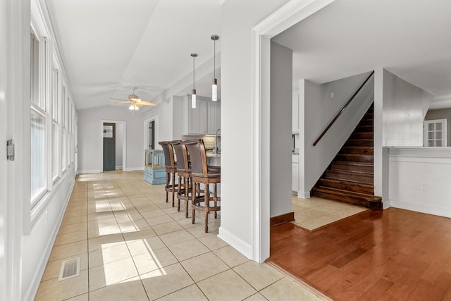 206 Chaussee Blvd, Summerville, SC 29483 - hallway with light tile patterned flooring, baseboards, vaulted ceiling, and stairs