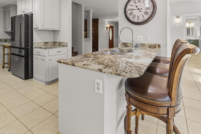 206 Chaussee Blvd, Summerville, SC 29483 - kitchen with a sink, freestanding refrigerator, a kitchen bar, and light tile patterned floors