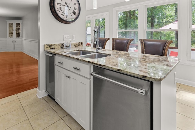 206 Chaussee Blvd, Summerville, SC 29483 - kitchen with dishwasher, a sink, light tile patterned floors, white cabinets, and french doors