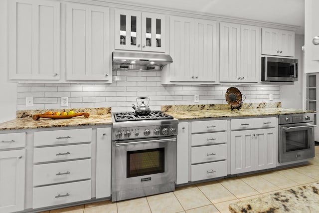 206 Chaussee Blvd, Summerville, SC 29483 - kitchen featuring stainless steel appliances, under cabinet range hood, tasteful backsplash, light tile patterned floors, and light stone countertops
