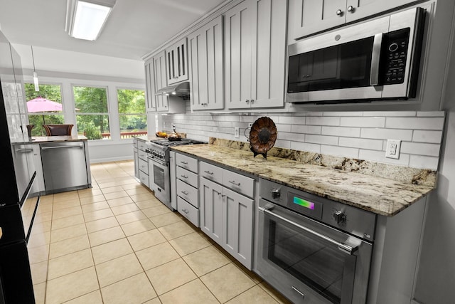 206 Chaussee Blvd, Summerville, SC 29483 - kitchen with stainless steel appliances, light tile patterned flooring, backsplash, gray cabinets, and light stone counters