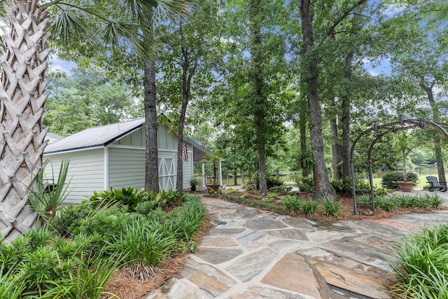 206 Chaussee Blvd, Summerville, SC 29483 - view of side of property with metal roof and view of scattered trees