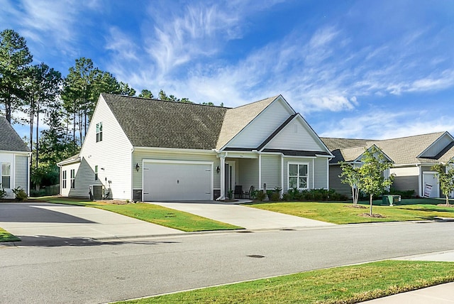 view of front facade featuring a shingled roof, concrete driveway, an attached garage, a front yard, and cooling unit