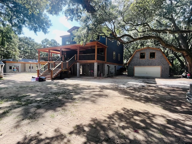 view of front facade with a garage and an outbuilding