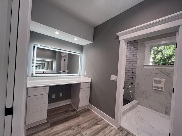 bathroom featuring vanity and tiled shower