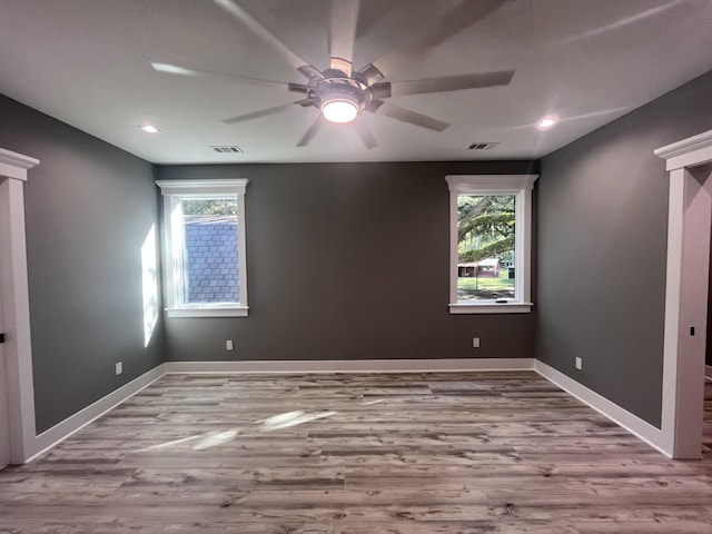 unfurnished room featuring ceiling fan, a healthy amount of sunlight, and light hardwood / wood-style flooring