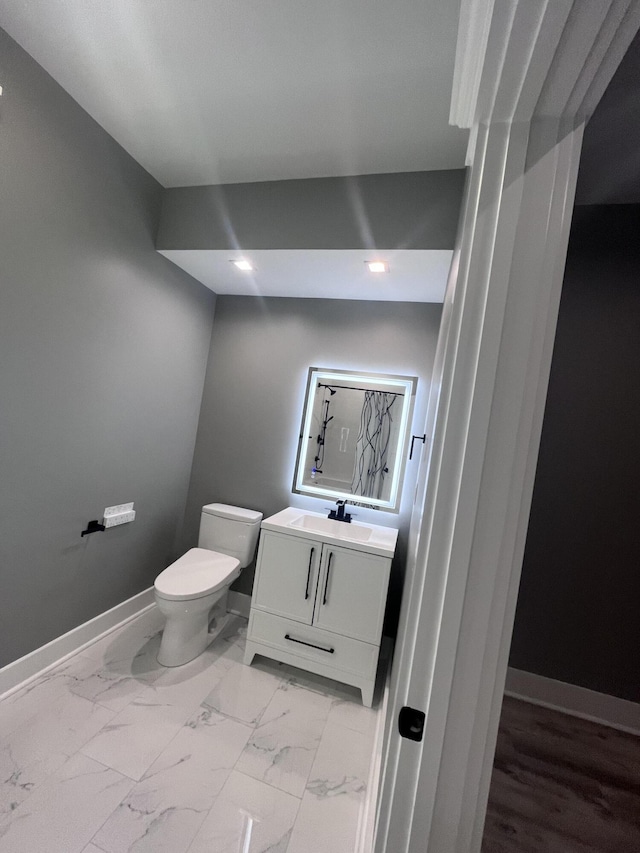 bathroom featuring vanity and toilet