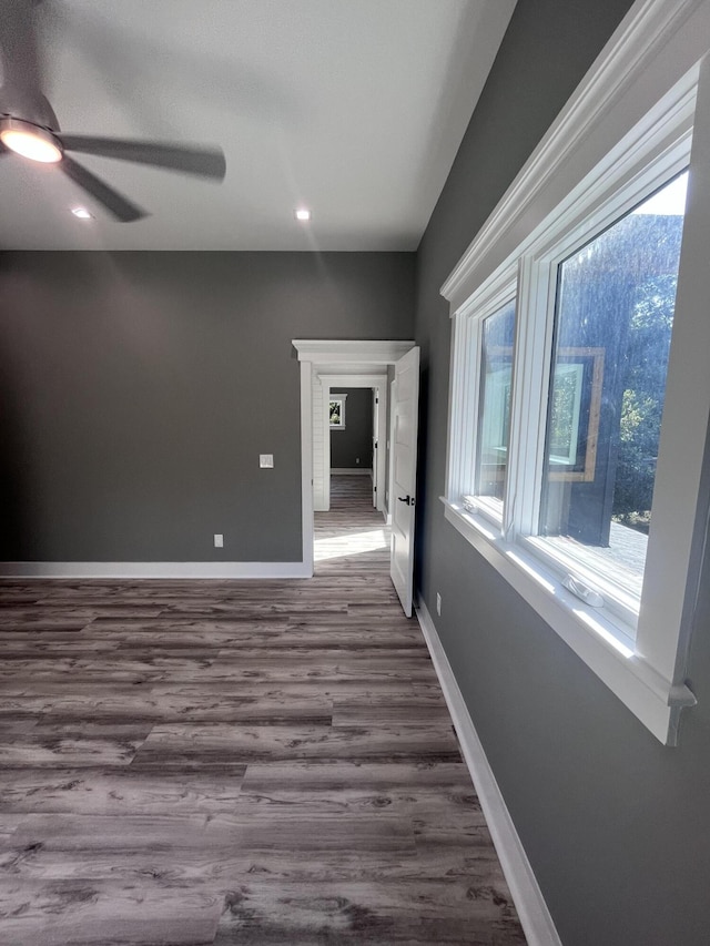 spare room with ceiling fan and dark hardwood / wood-style flooring