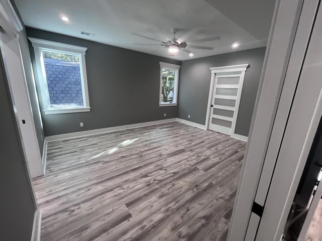 unfurnished bedroom with ceiling fan and light hardwood / wood-style flooring