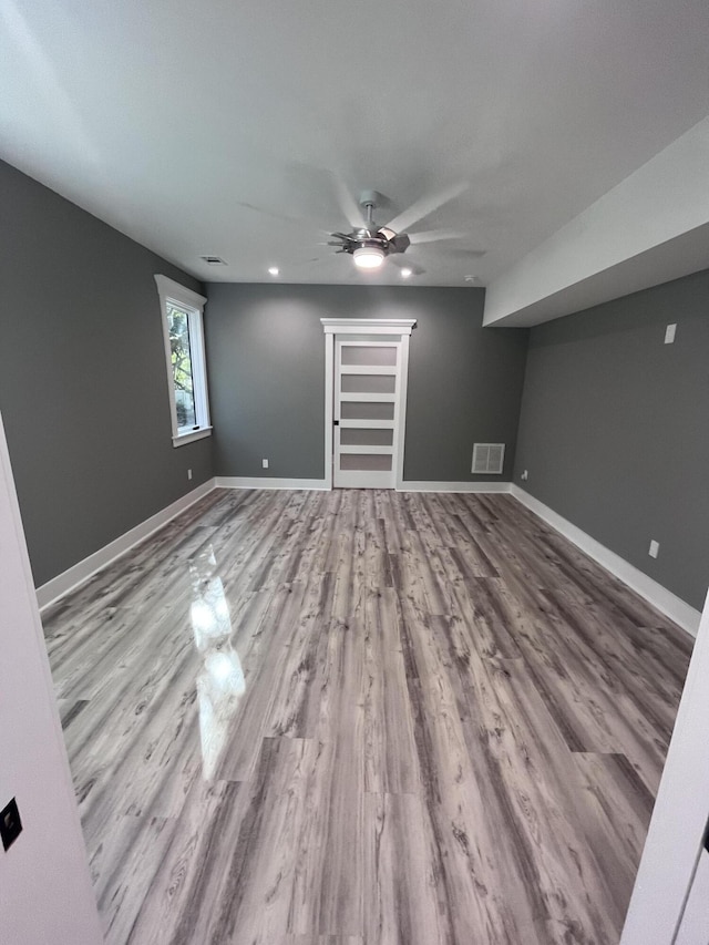 interior space with light hardwood / wood-style floors and ceiling fan