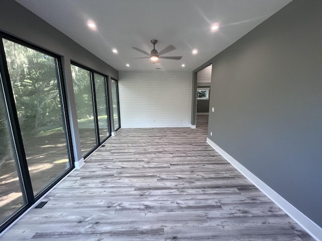 spare room featuring light hardwood / wood-style flooring and ceiling fan