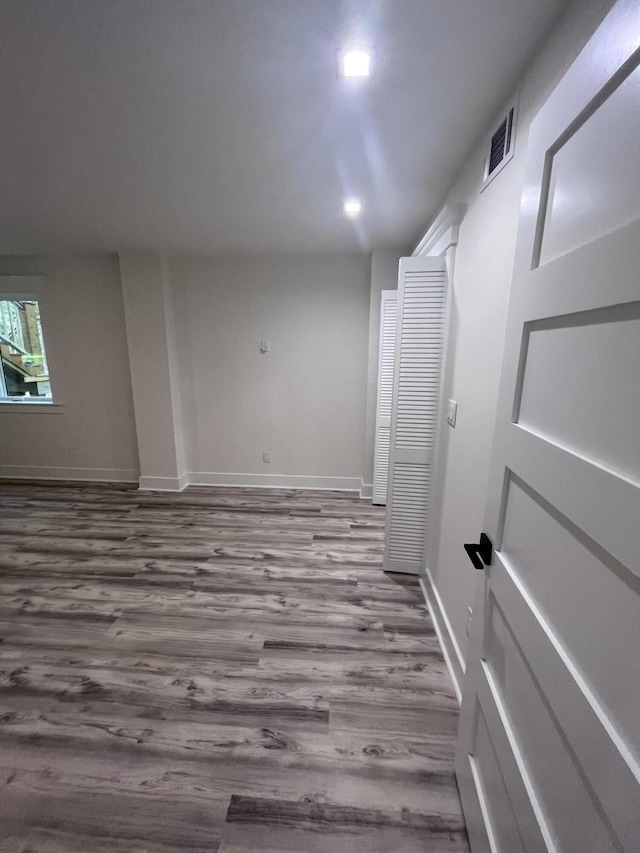 unfurnished room with hardwood / wood-style floors