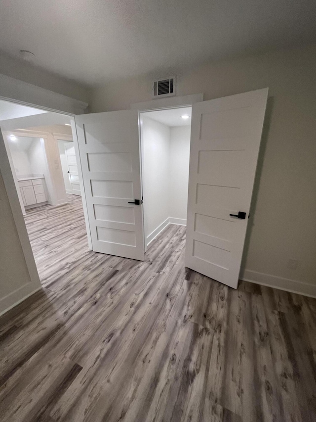 empty room with wood-type flooring