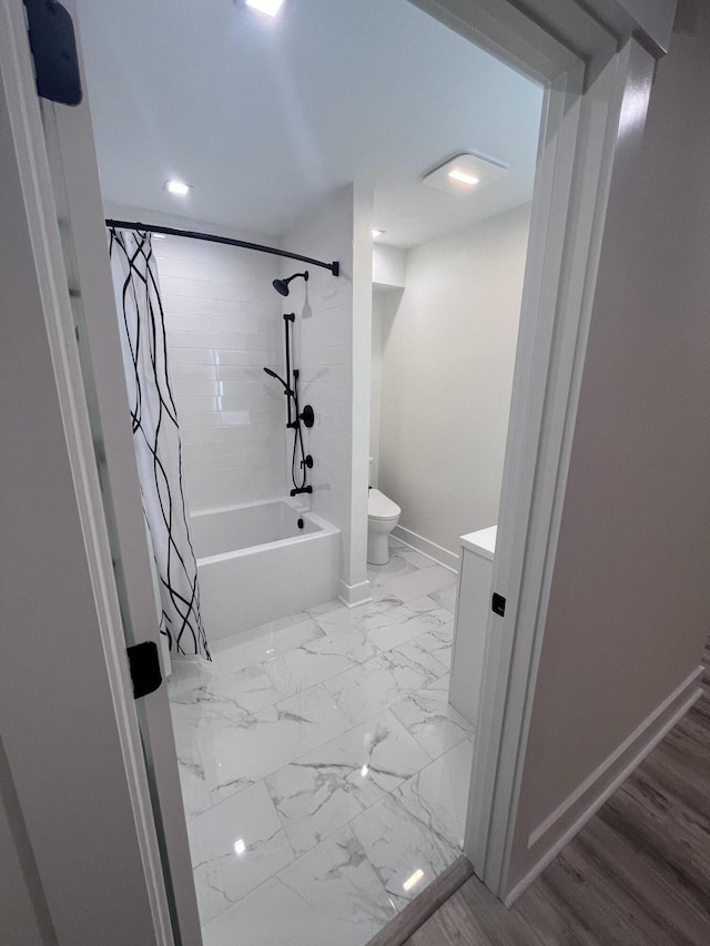 bathroom with toilet and shower / bath combo with shower curtain