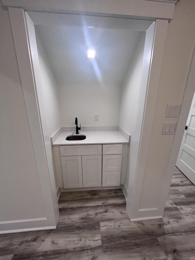 bathroom featuring hardwood / wood-style flooring and vanity