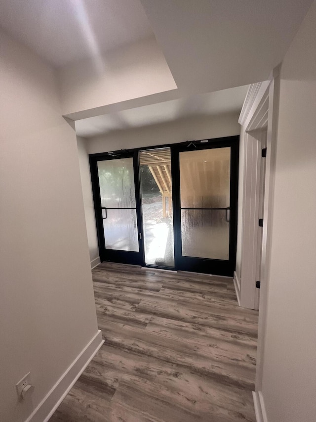 corridor with wood-type flooring