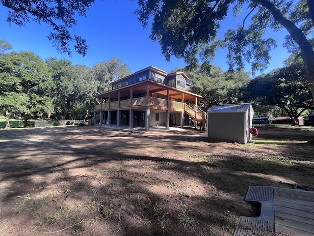 back of property with a storage shed and a deck