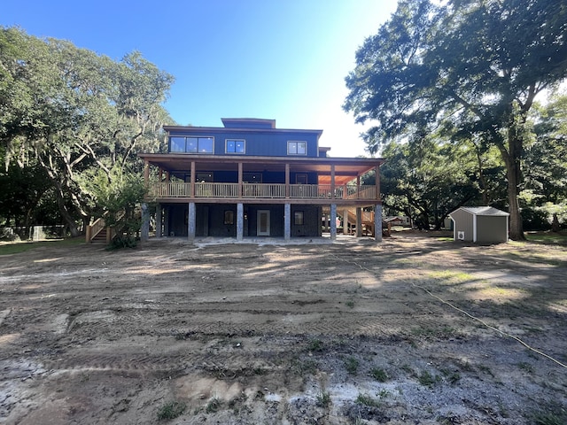 rear view of property featuring a shed