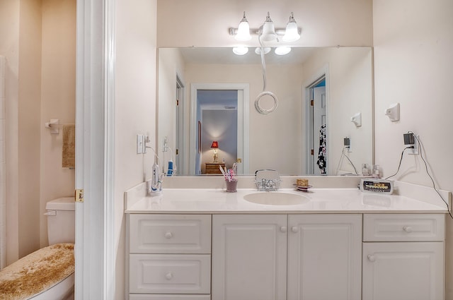 bathroom featuring toilet and vanity