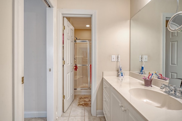 bathroom featuring vanity, tile patterned flooring, and a shower with shower door