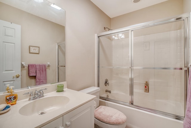 full bathroom with toilet, enclosed tub / shower combo, and vanity