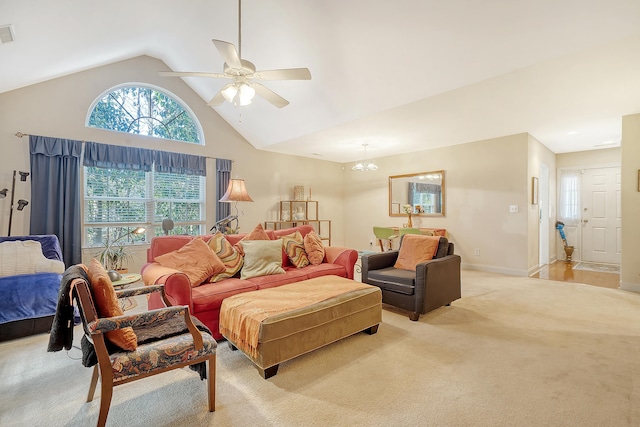 carpeted living room featuring ceiling fan and vaulted ceiling