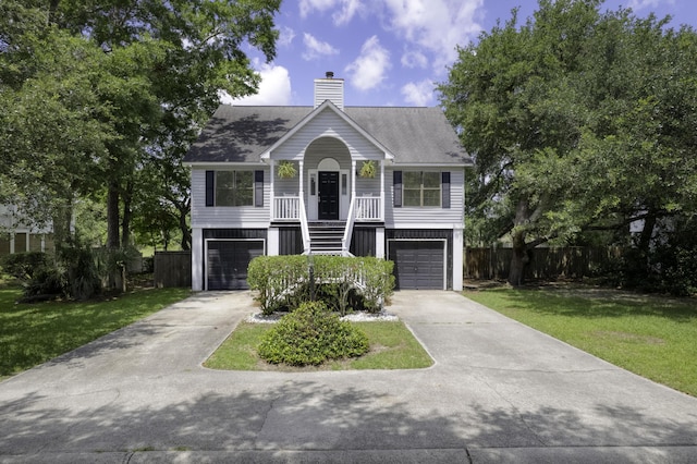 633 Stono Edge Dr, Charleston, SC 29412 - raised beach house featuring concrete driveway, a chimney, stairway, and a garage
