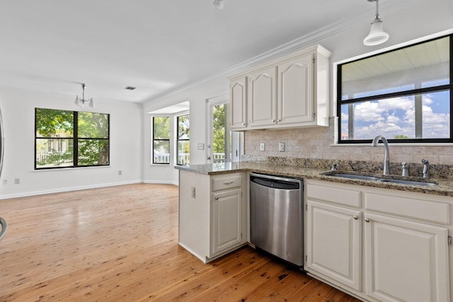 633 Stono Edge Dr, Charleston, SC 29412 - kitchen with stainless steel dishwasher, backsplash, open floor plan, crown molding, and light wood-type flooring