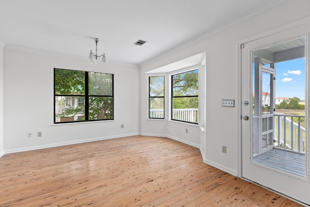633 Stono Edge Dr, Charleston, SC 29412 - spare room with plenty of natural light, light wood-type flooring, a chandelier, and crown molding