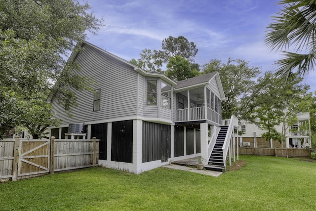 633 Stono Edge Dr, Charleston, SC 29412 - back of property featuring a sunroom, stairway, ceiling fan, and a gate