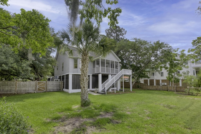633 Stono Edge Dr, Charleston, SC 29412 - rear view of property featuring a sunroom, a fenced backyard, a gate, and stairway