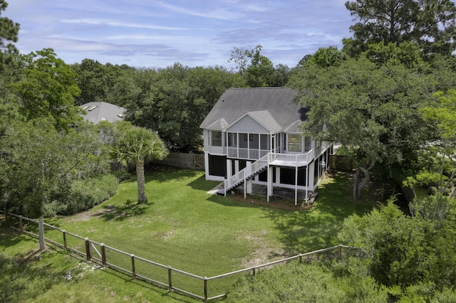 633 Stono Edge Dr, Charleston, SC 29412 - rear view of property featuring a sunroom, a fenced backyard, stairs, a shingled roof, and a view of trees
