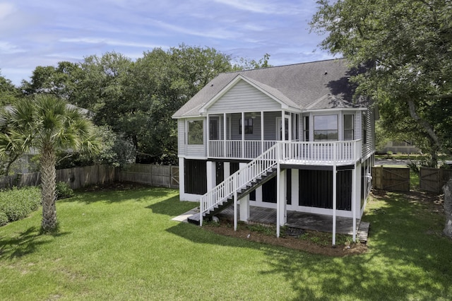 633 Stono Edge Dr, Charleston, SC 29412 - rear view of house featuring a sunroom, roof with shingles, a fenced backyard, and stairs