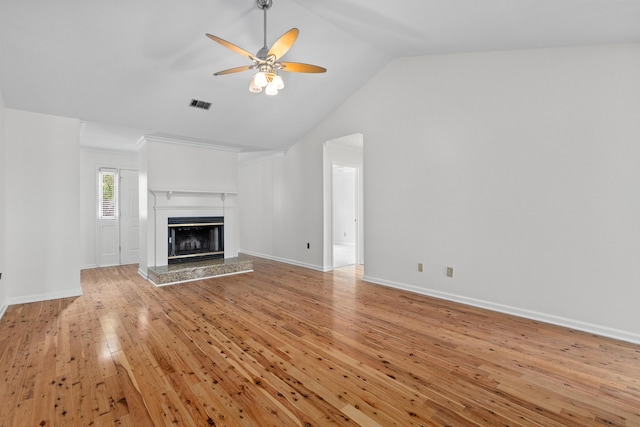 633 Stono Edge Dr, Charleston, SC 29412 - unfurnished living room with ceiling fan, vaulted ceiling, light wood-type flooring, and a glass covered fireplace