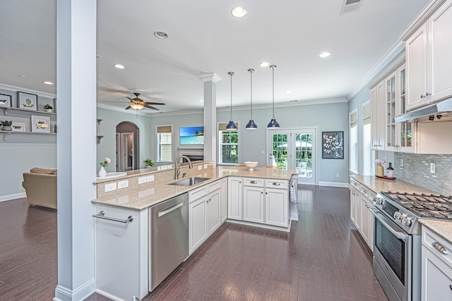 1721 Wellstead St, Mount Pleasant, SC 29466 - kitchen featuring stainless steel appliances, ornamental molding, dark wood-type flooring, glass insert cabinets, and white cabinets