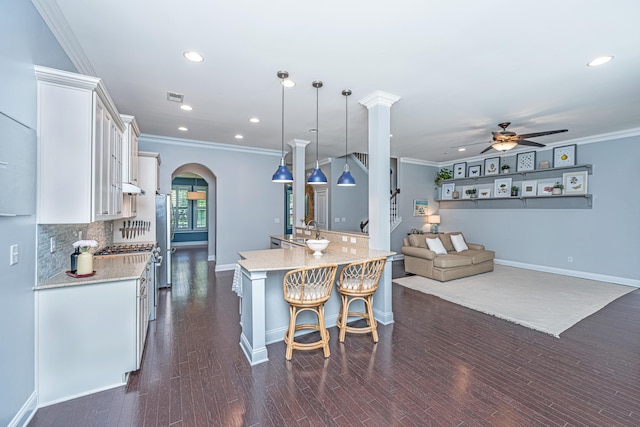 1721 Wellstead St, Mount Pleasant, SC 29466 - kitchen with ceiling fan, white cabinetry, arched walkways, recessed lighting, and tasteful backsplash