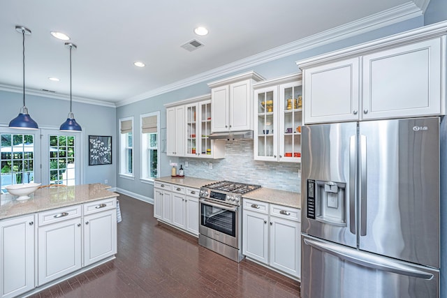 1721 Wellstead St, Mount Pleasant, SC 29466 - kitchen featuring appliances with stainless steel finishes, dark wood-style floors, decorative backsplash, light stone counters, and hanging light fixtures
