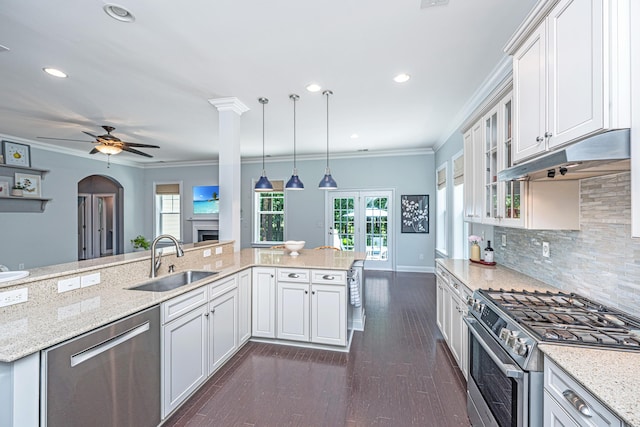 1721 Wellstead St, Mount Pleasant, SC 29466 - kitchen featuring appliances with stainless steel finishes, a ceiling fan, white cabinetry, tasteful backsplash, and glass insert cabinets
