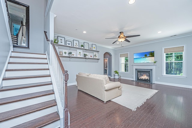 1721 Wellstead St, Mount Pleasant, SC 29466 - living area featuring a fireplace with flush hearth, crown molding, stairway, a ceiling fan, and arched walkways