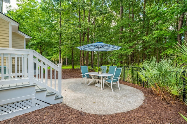 1721 Wellstead St, Mount Pleasant, SC 29466 - view of patio with view of wooded area, outdoor dining space, and stairway